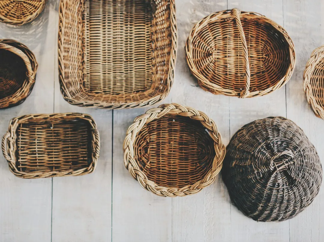 A weaver finishing the handle of a woven beach tote in a small workshop