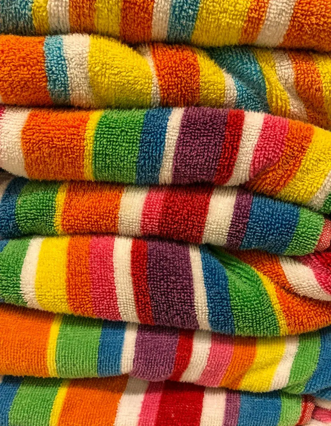Folded quick-dry towels in coastal colours