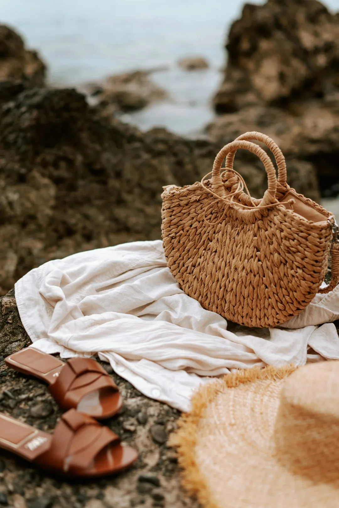 A bundled set of a woven bag, sun hat and quick-dry towel tied together
