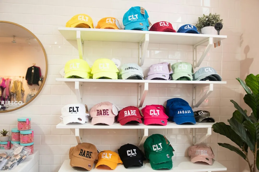 A seasonal display of beach bags and hats laid out on a wooden shelf